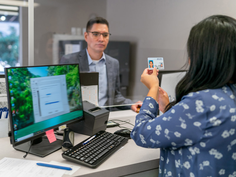 photo of woman checking a mans identity